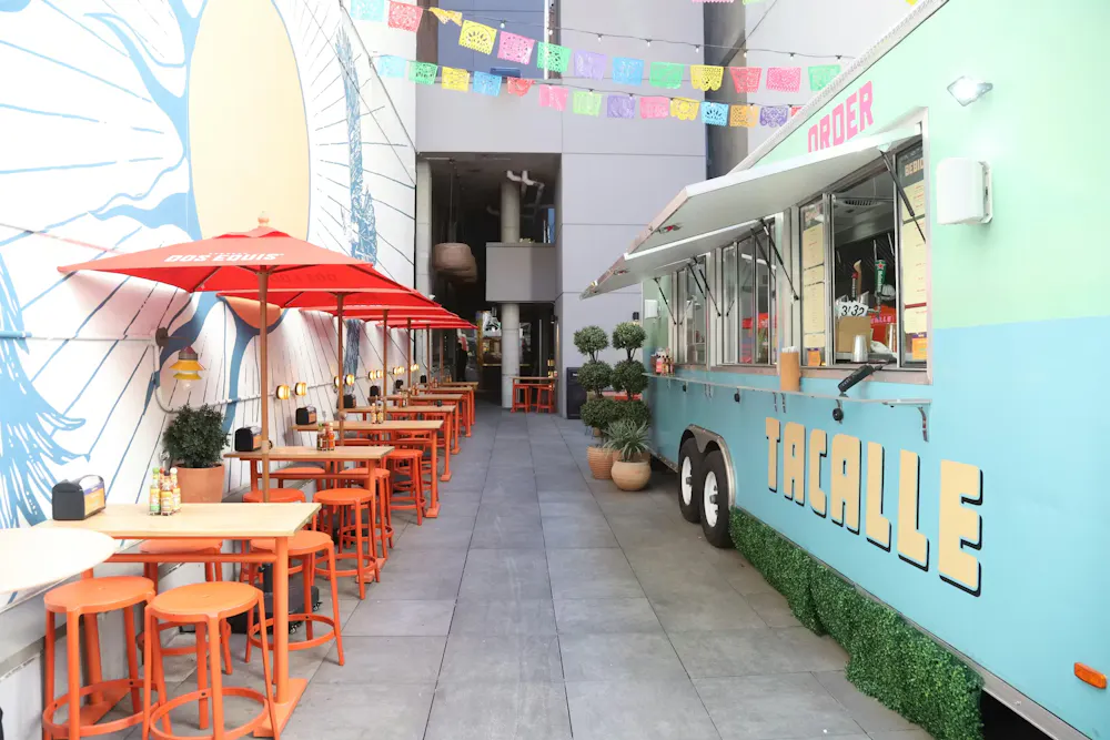 a food truck with tables and chairs outside