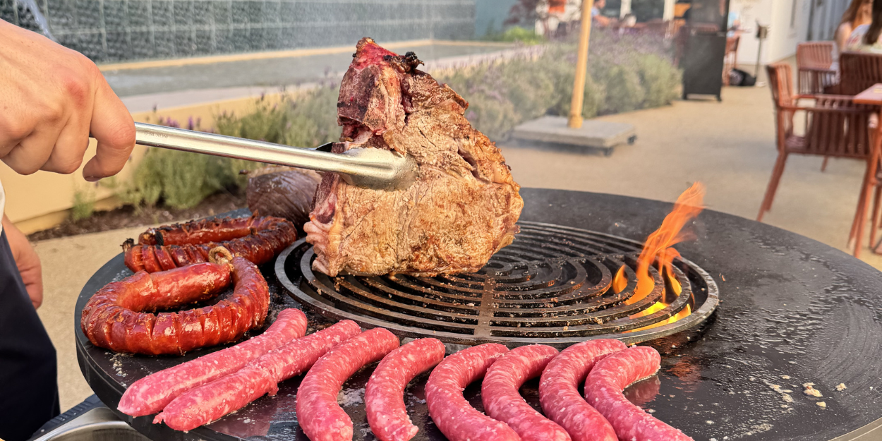 meat on a grill with sausages