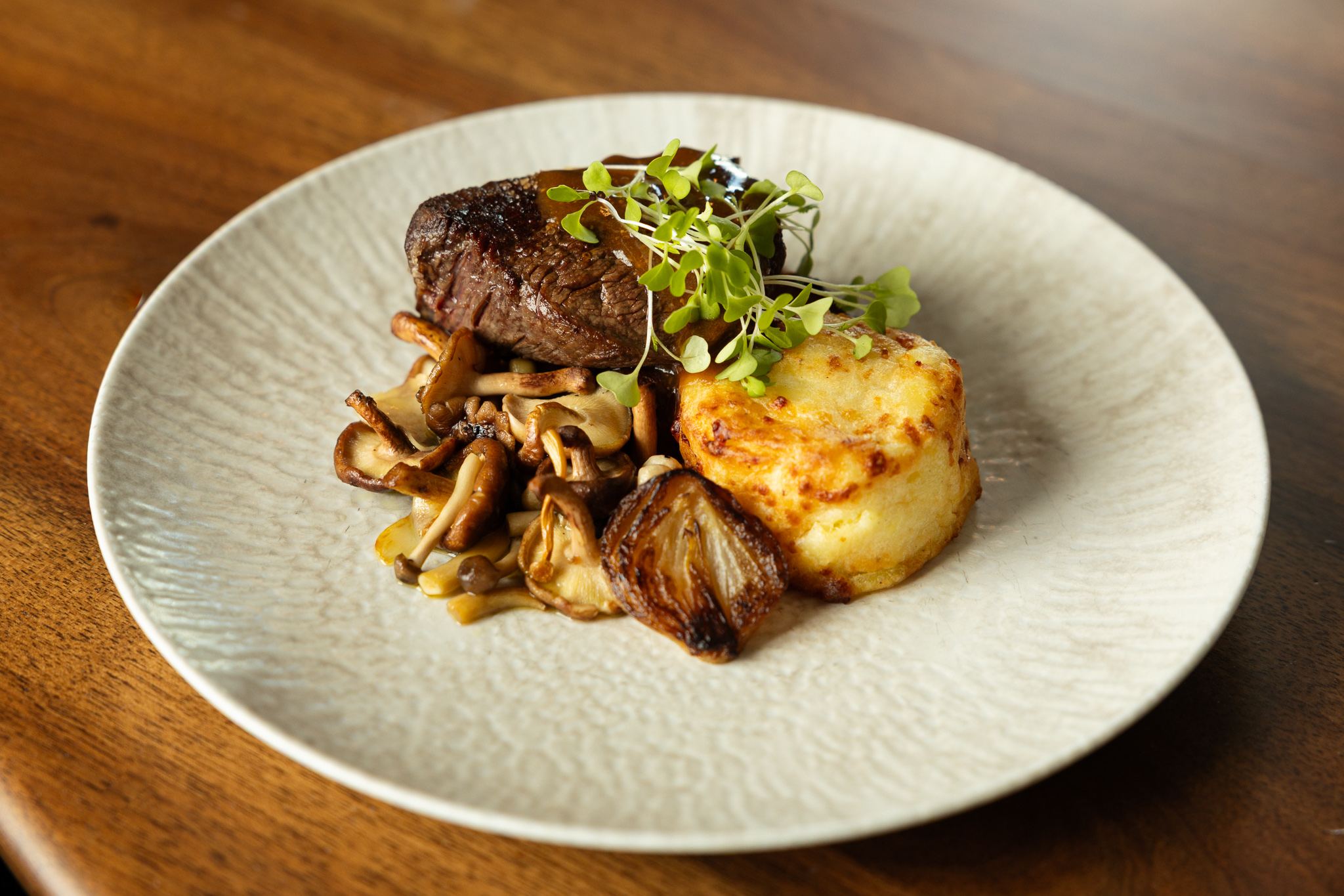 a plate of food on a wood table