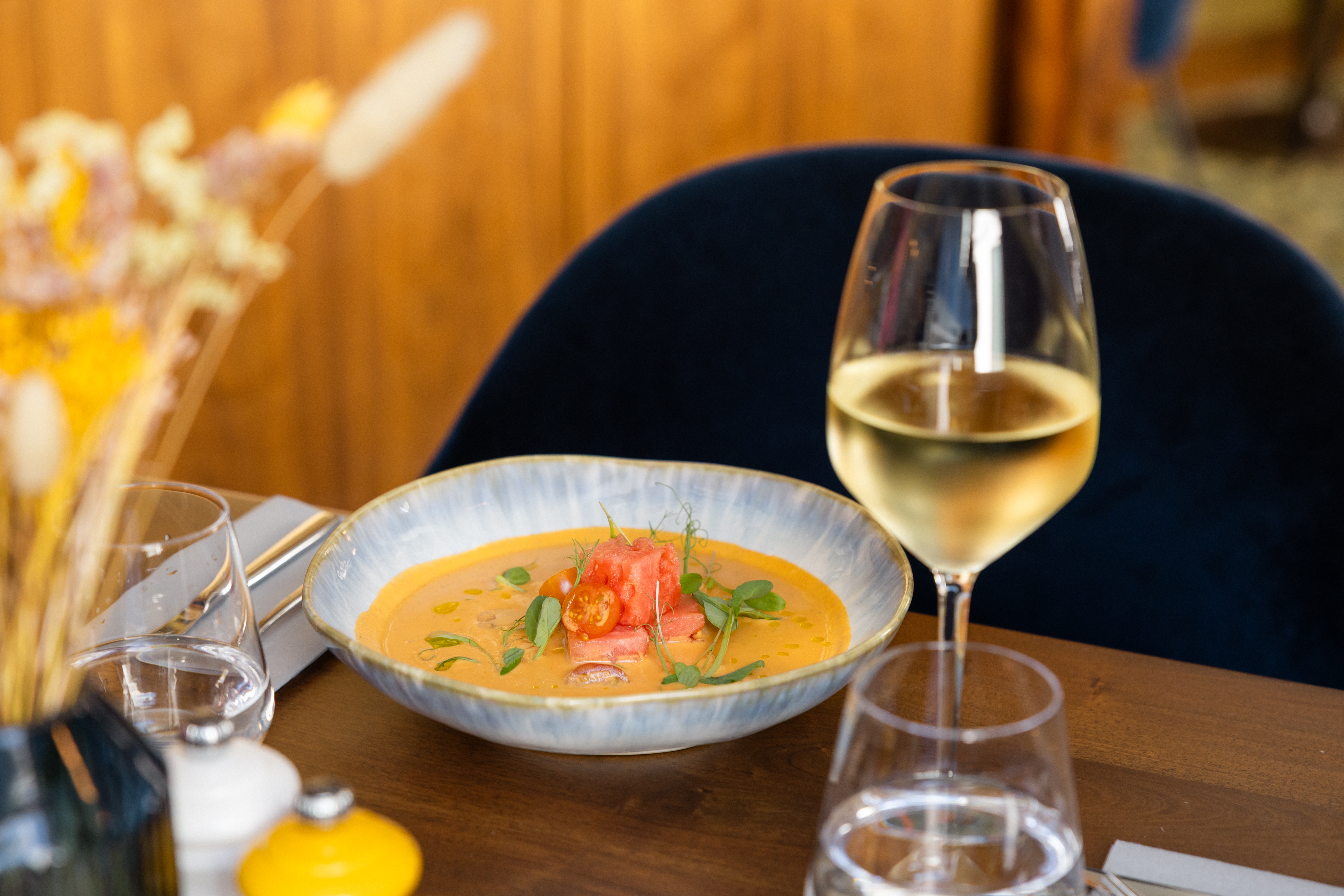 a bowl of soup and a glass of wine