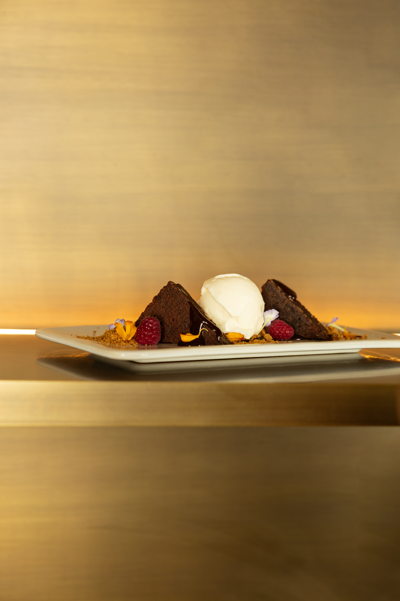 a plate of dessert with ice cream and fruit