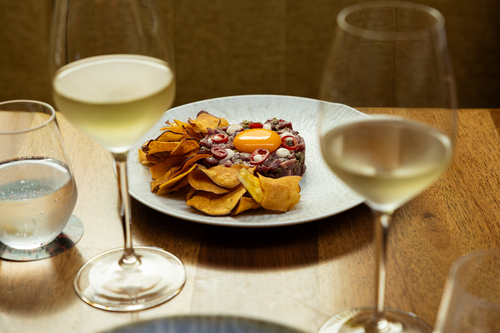 a plate of food and wine glasses