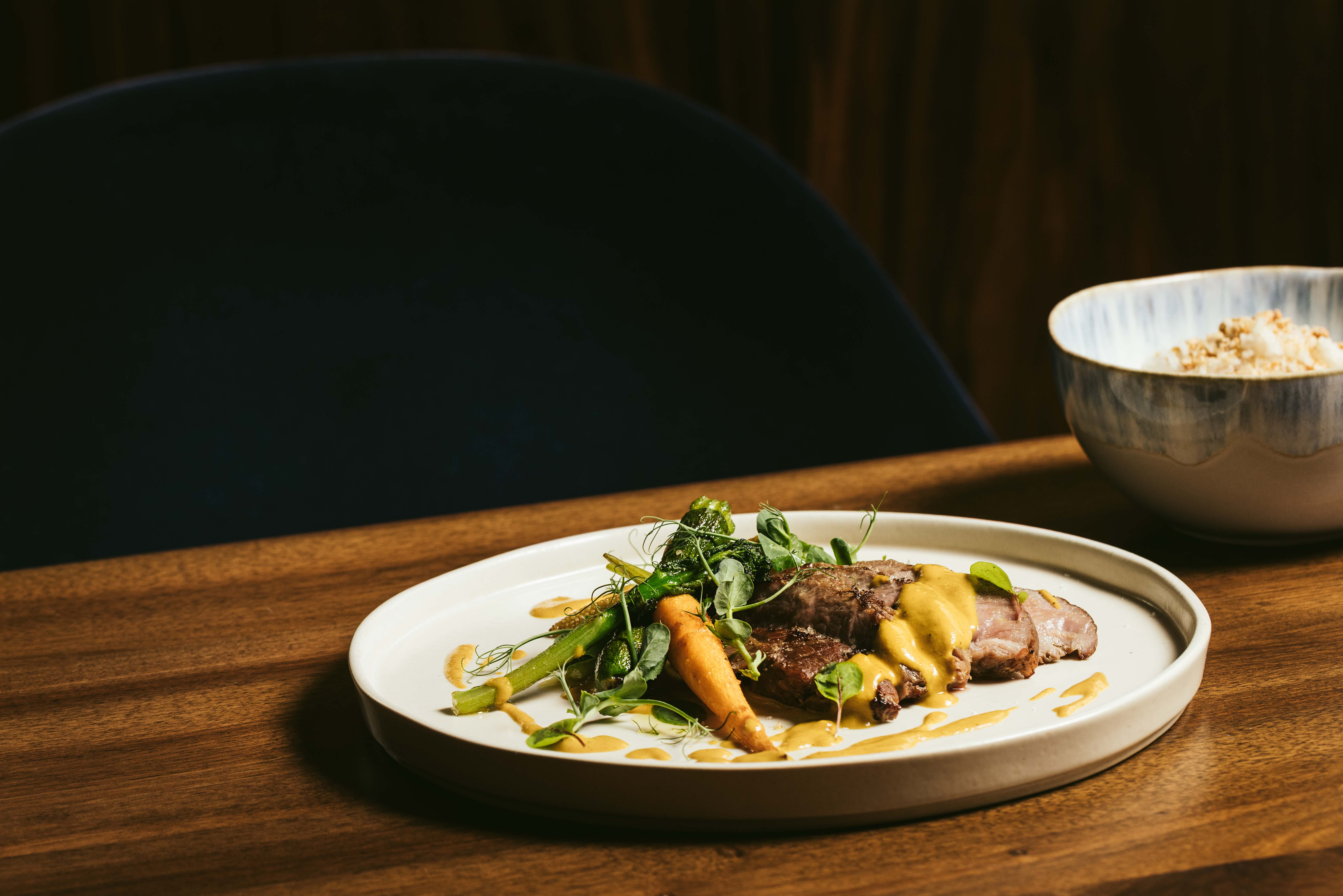 a bowl of food on a plate on a table