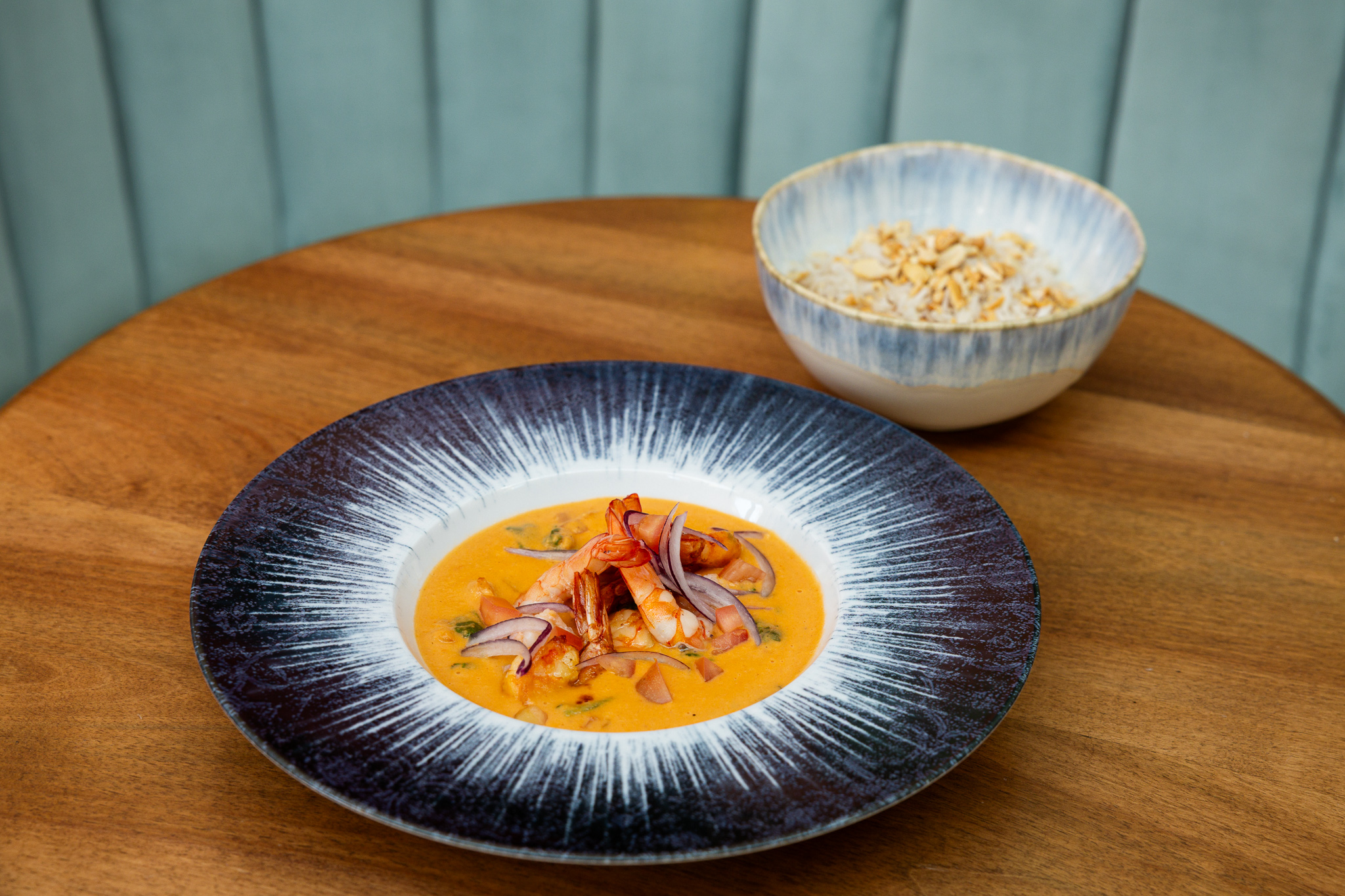 a bowl of soup and rice on a table