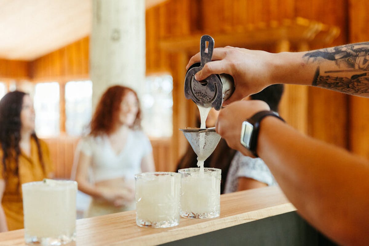 a person sitting at a table with a cup of coffee
