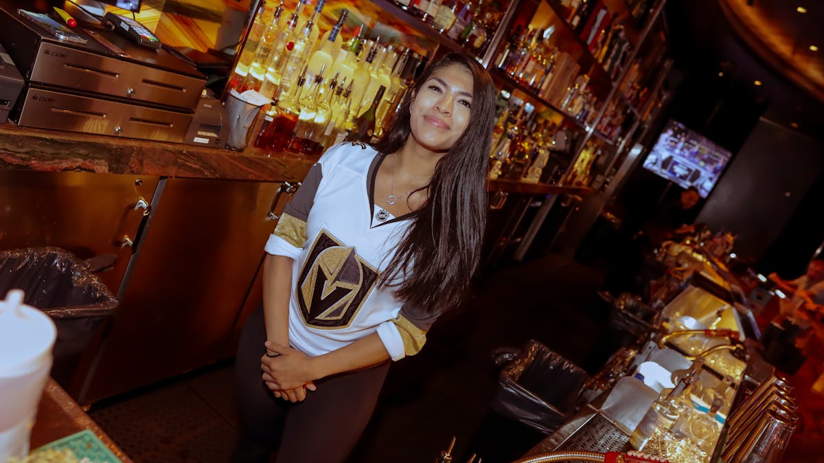 bartender at clique bar and lounge watching golden knights play