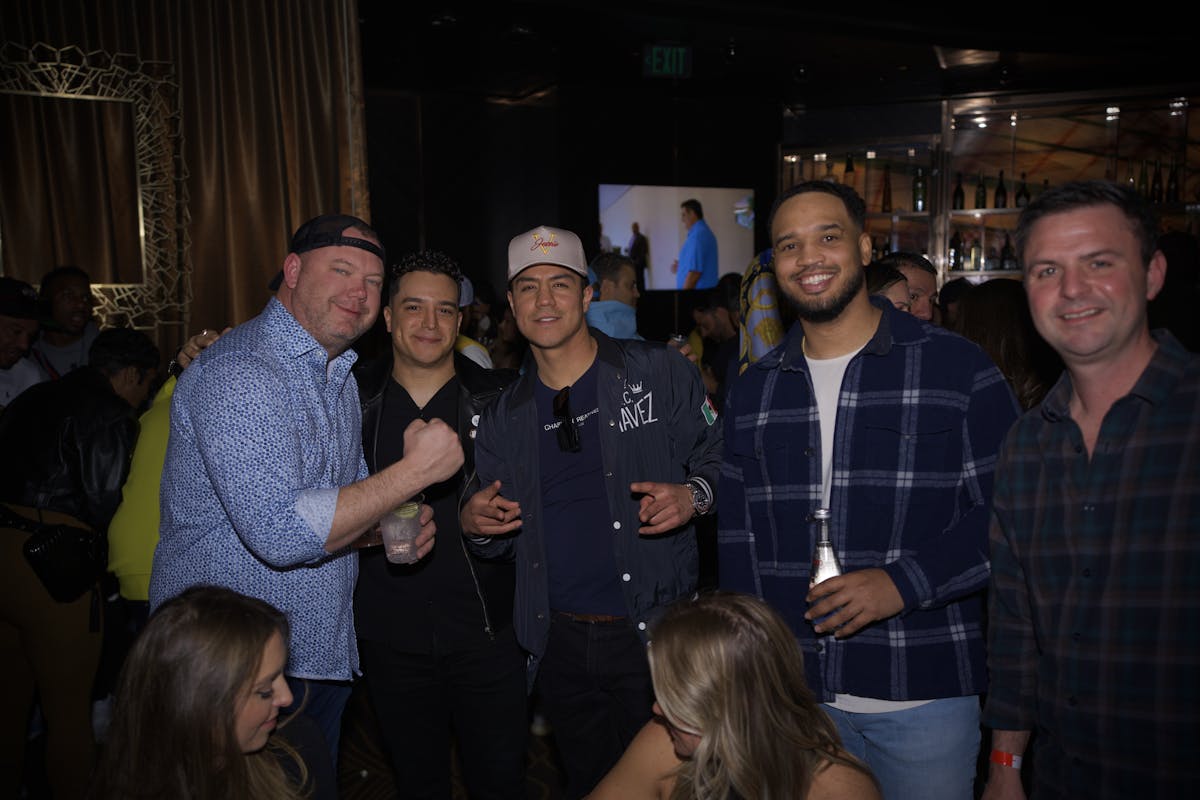 Jessie Vargas et al. standing next to a wine glass