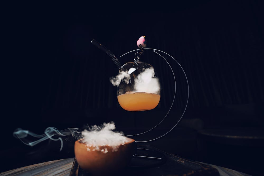 one flew over drink with smoke and a baby bird