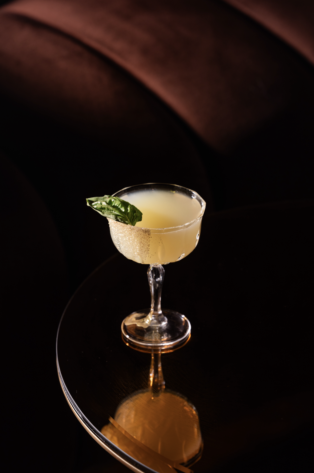 Golden Leaf cocktail with basil garnish and a sugared rim at Clique Bar & Lounge in Las Vegas