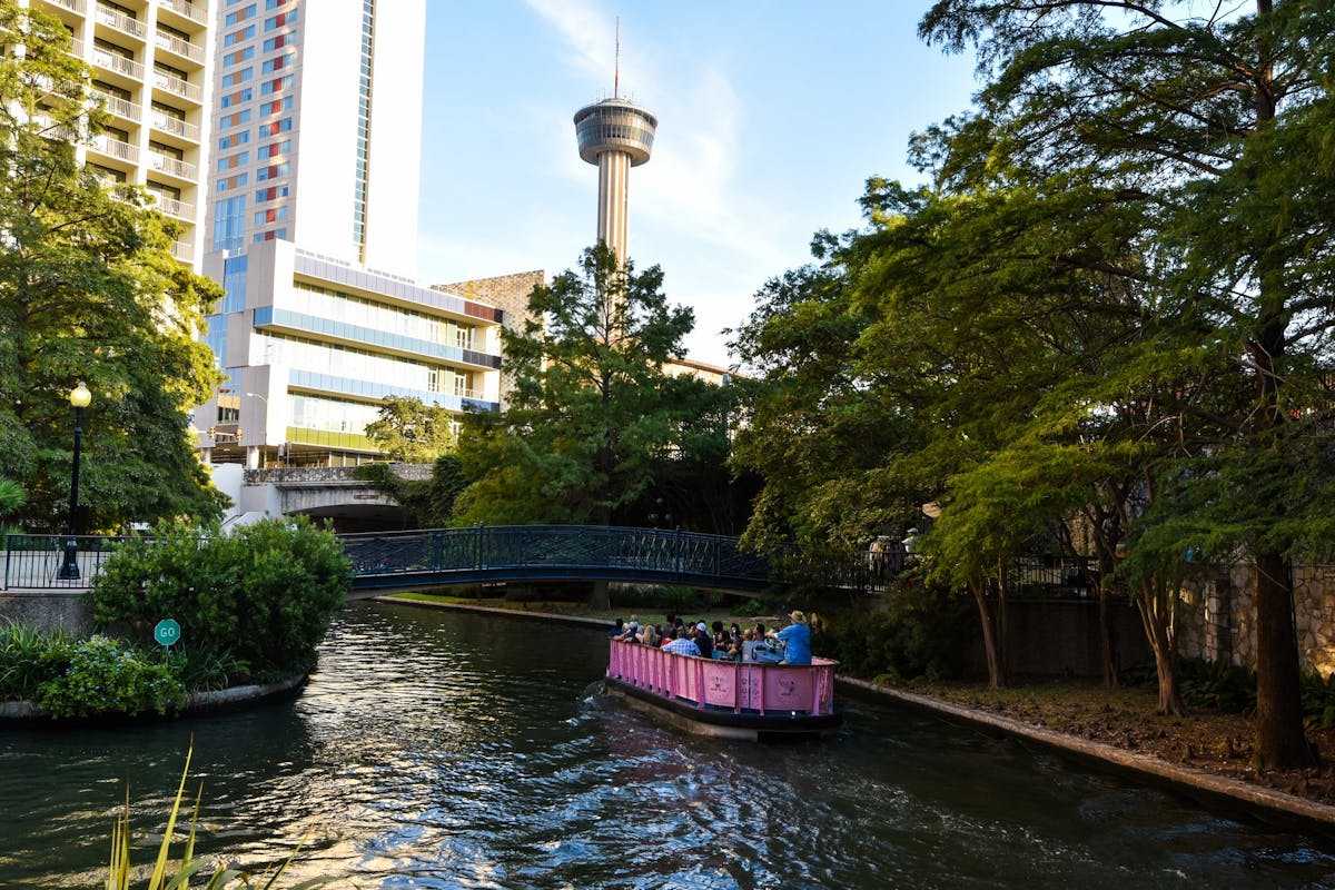 a boat traveling down a river in a city