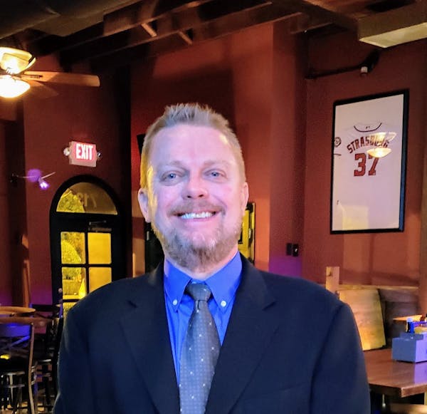 Tom Johnson, Managing partner of HRG, smiling in bar