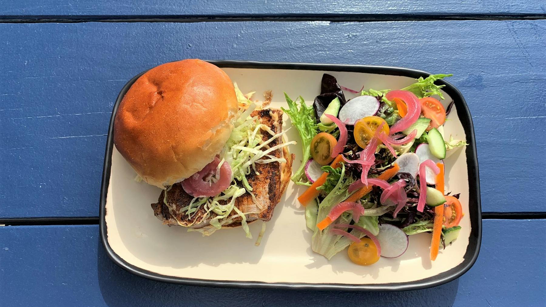 a plate of food with a sandwich and a salad