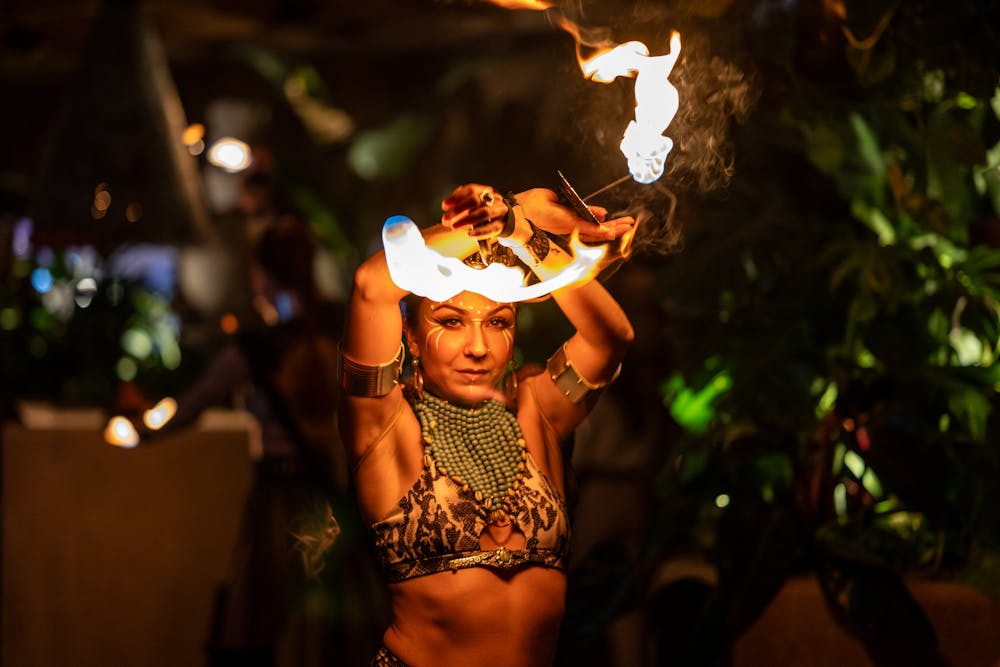 a woman standing in front of a fire