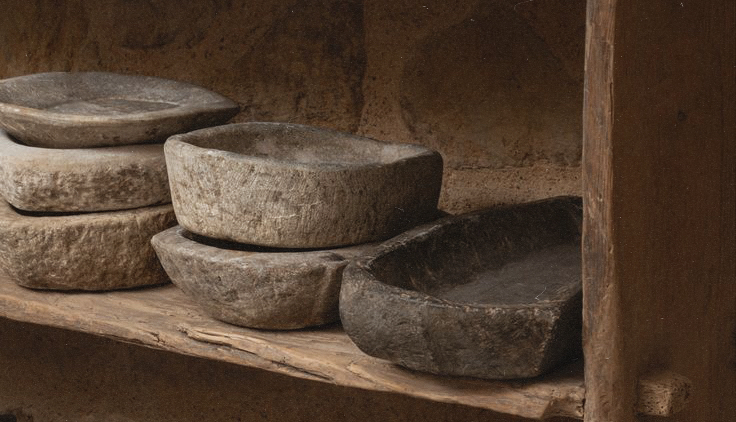 a close up of natural wooden plates on a shelf