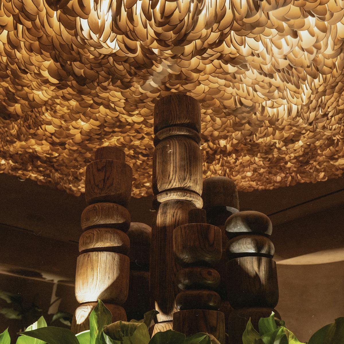 a photo of the chandelier and totems inside amaya modern mexican