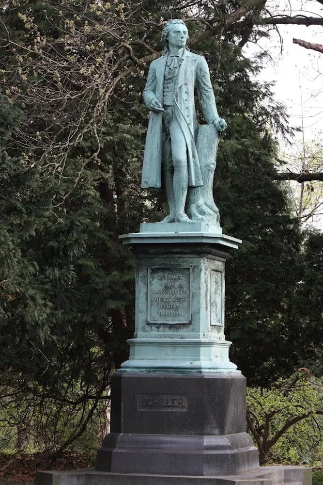Schiller a person standing in front of a statue