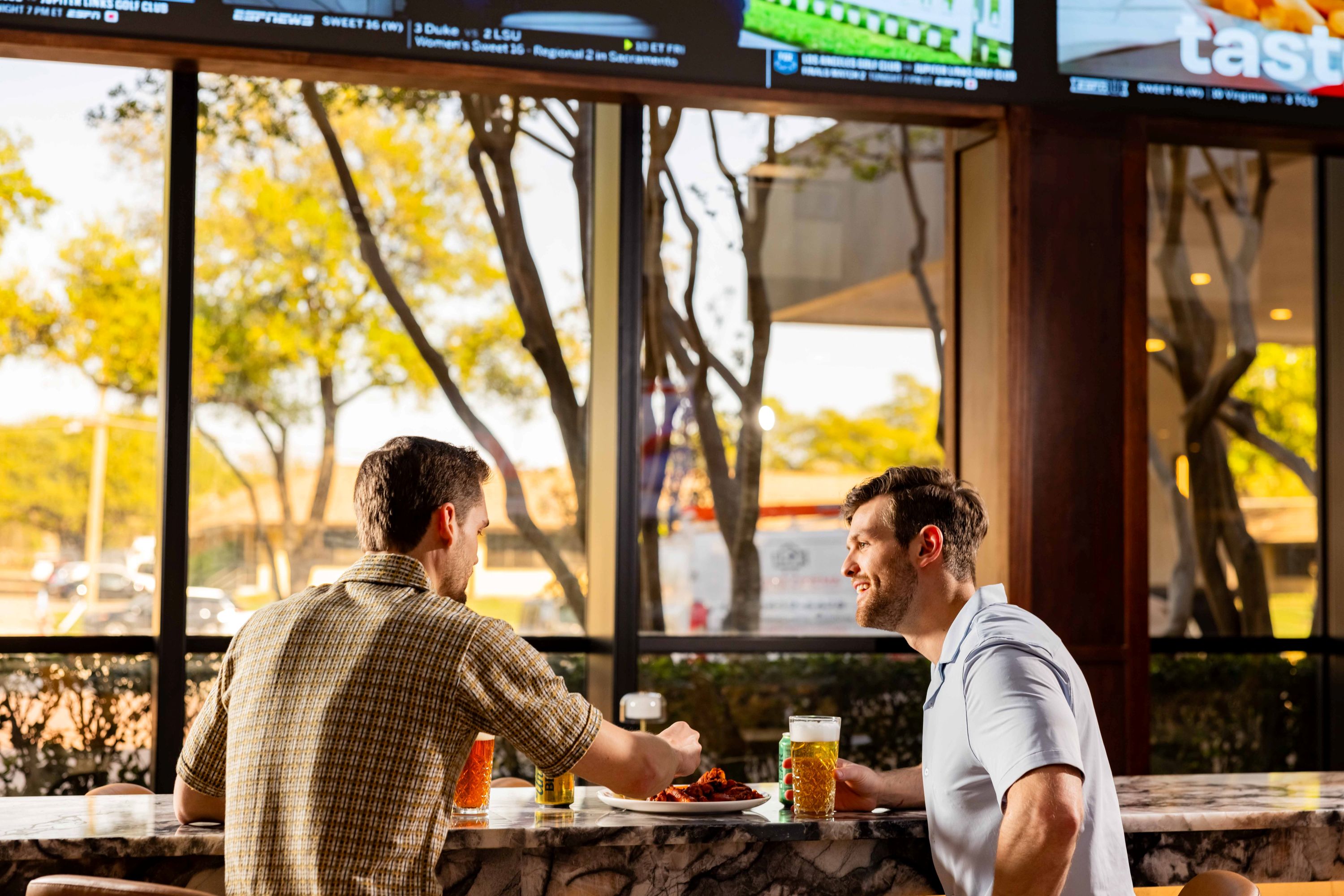 two men sitting at a bar