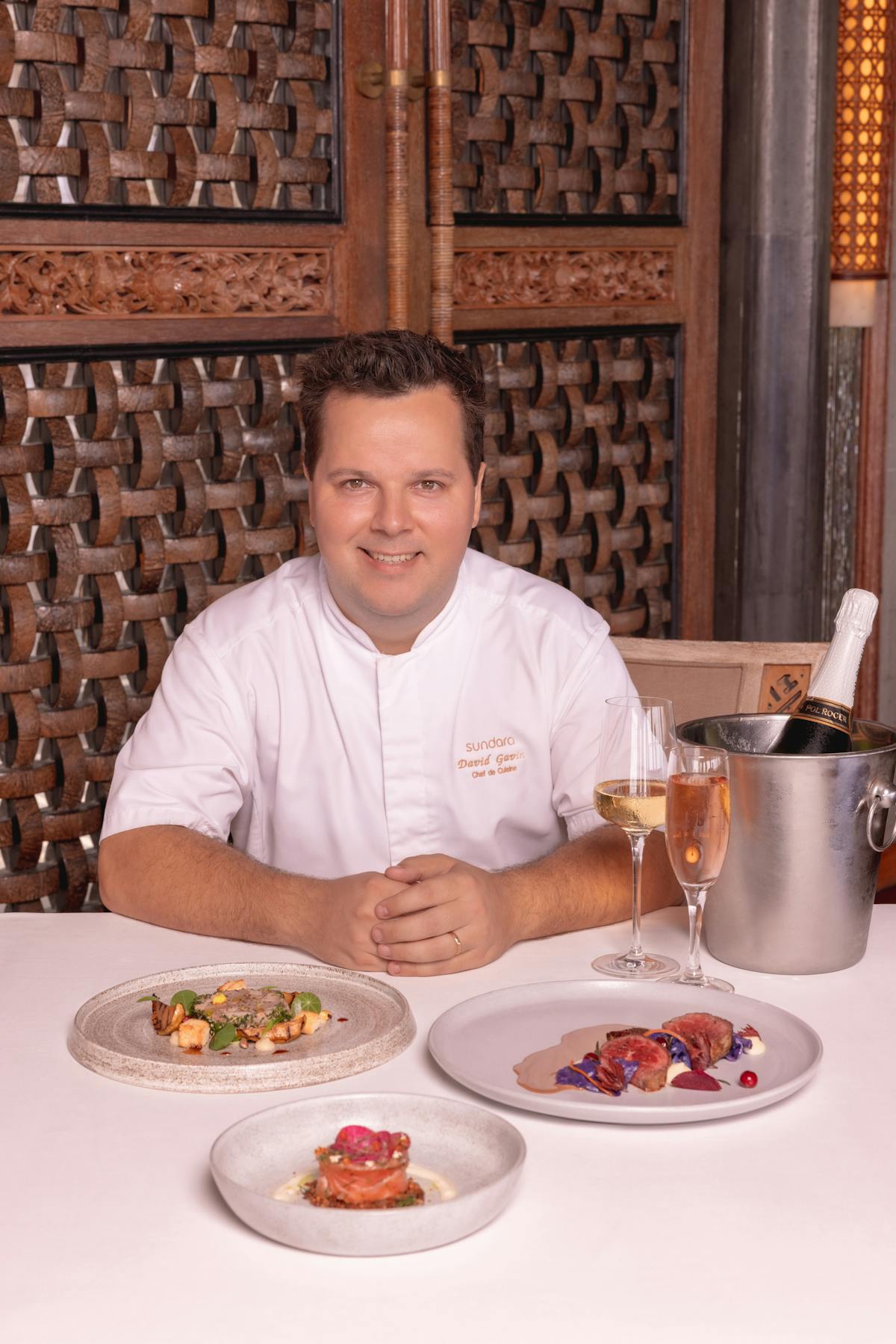 a man sitting at a table with a plate of food