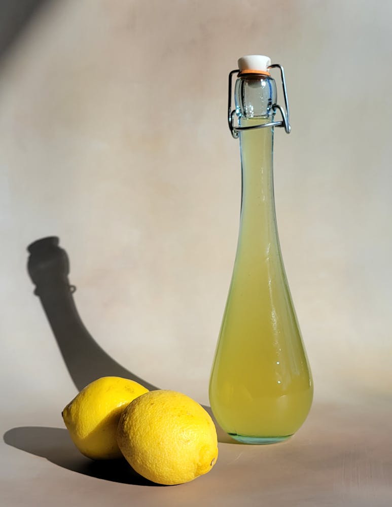 a bottle and a glass of orange juice