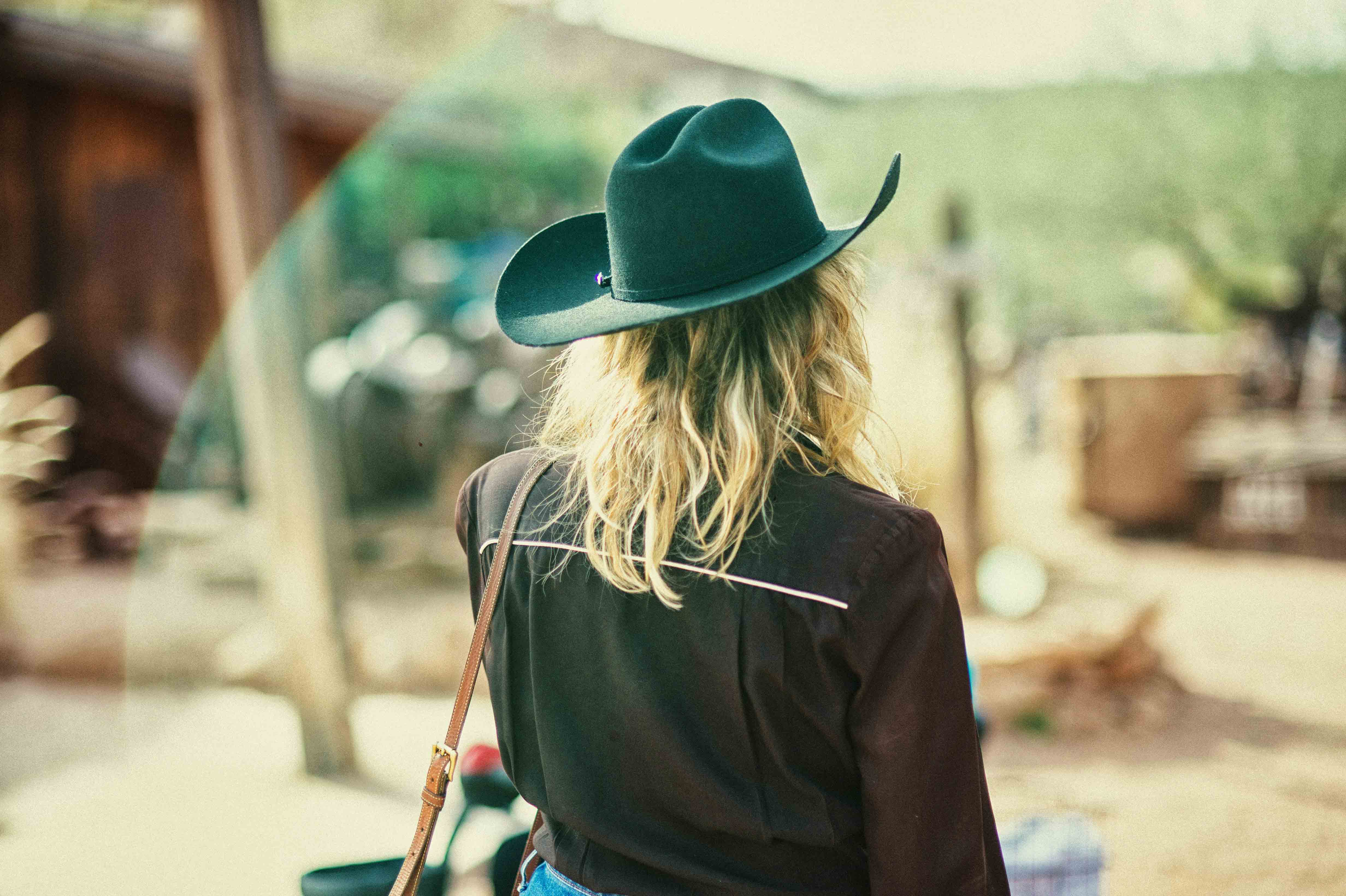 a woman using a cowboy hat
