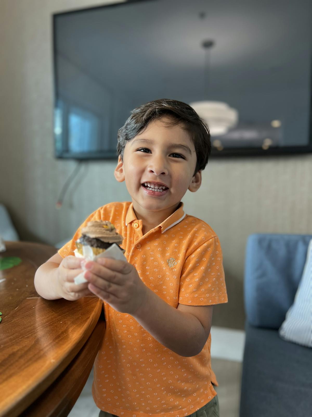 a young boy sitting at a table eating food