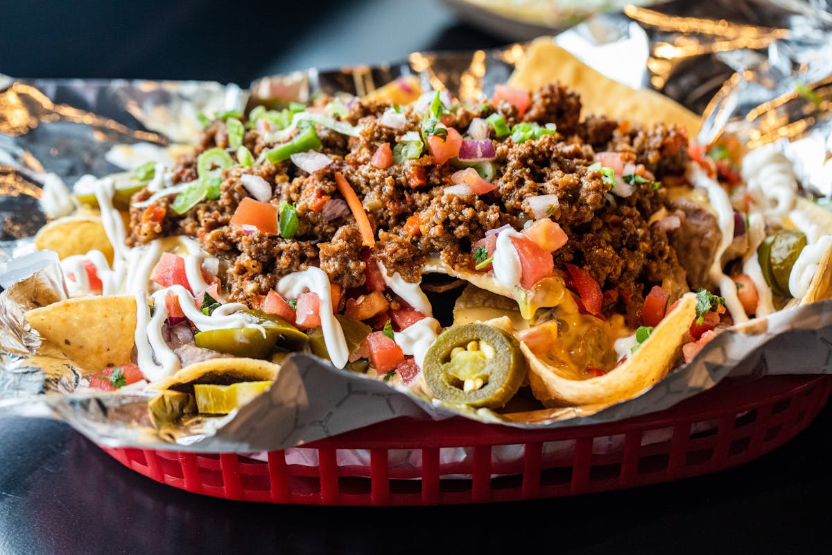Loaded nachos with lots of meat at Tacos A Go Go in Houston