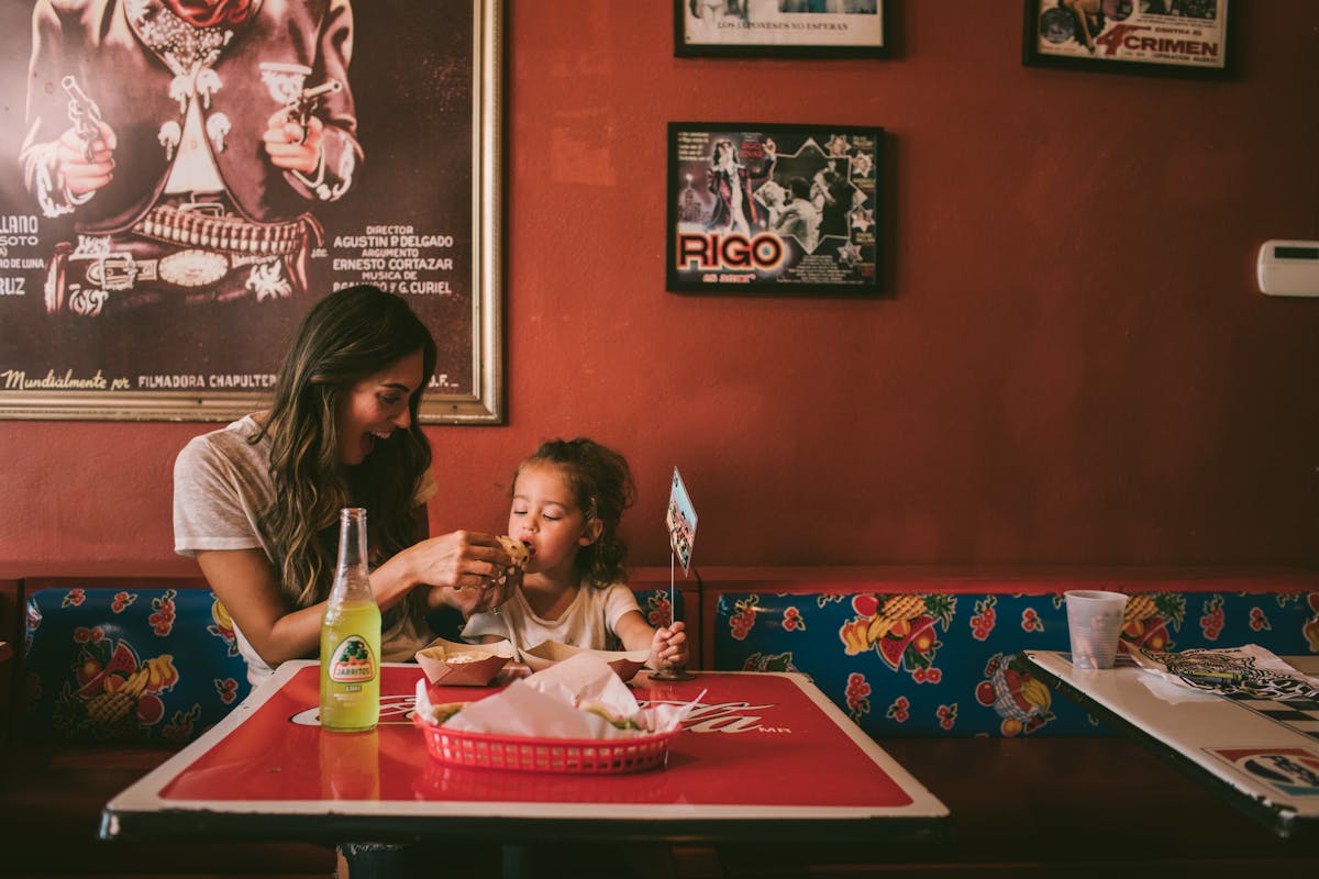 A mother and her daughter sharing tacos at Tacos A Go Go