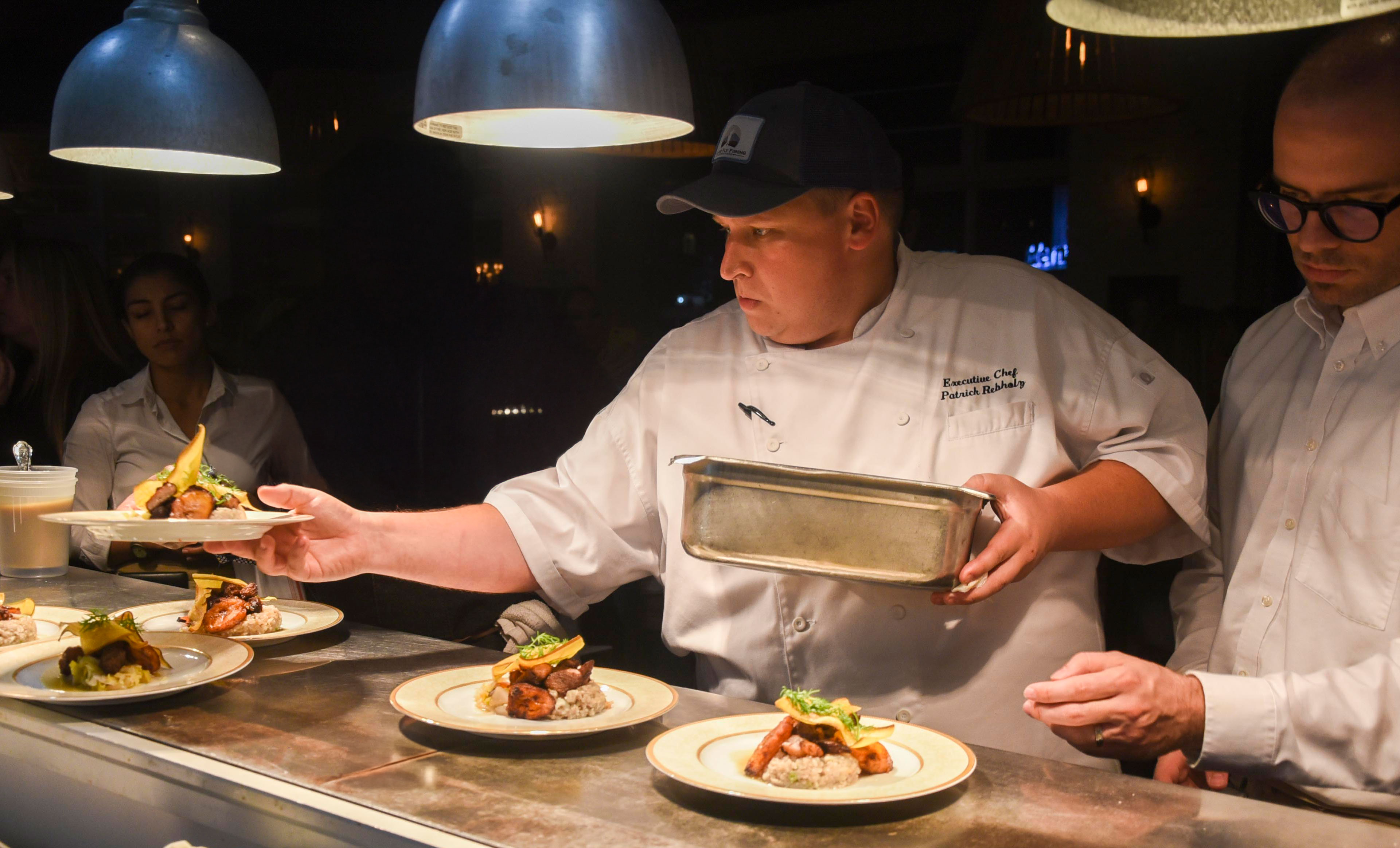 a person sitting at a table with a plate of food