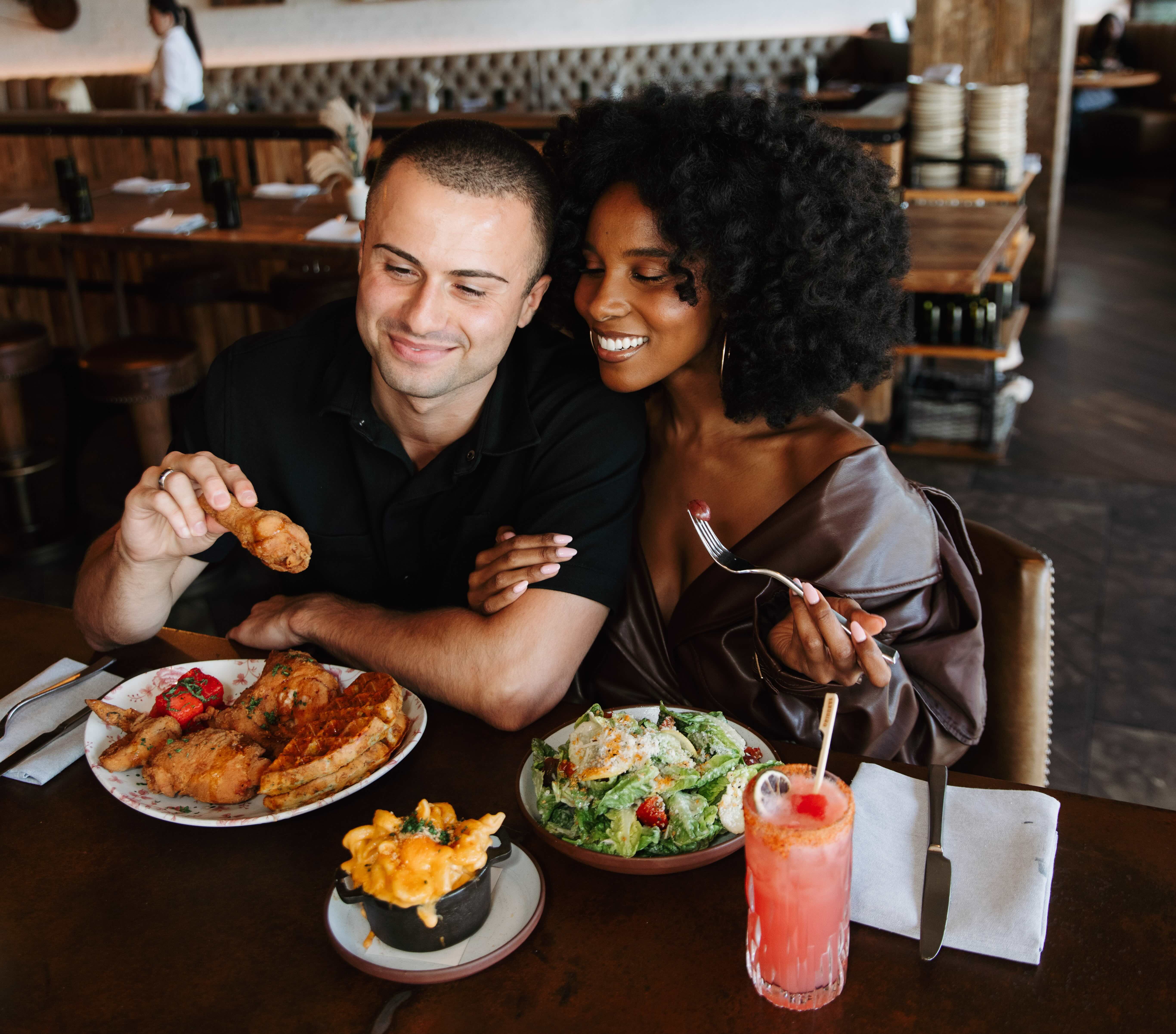 a group of people sitting at a table with a plate of food