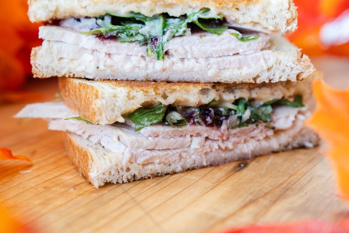 a cut in half sandwich sitting on top of a wooden table