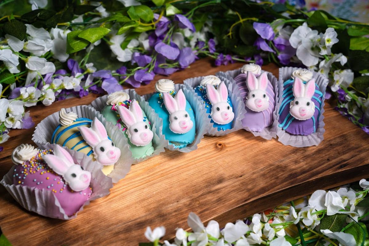 a group of stuffed animals sitting on top of a wooden table