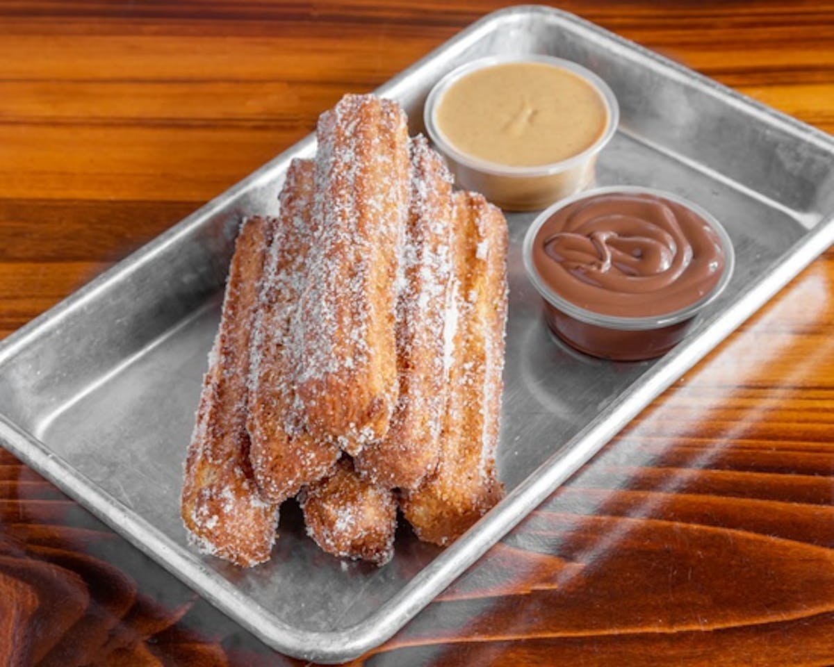 a tray of churros on a table