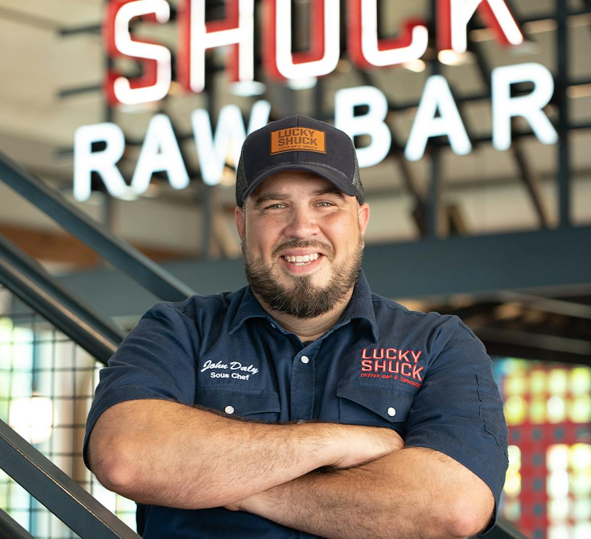 executive chef standing in front of a raw bar