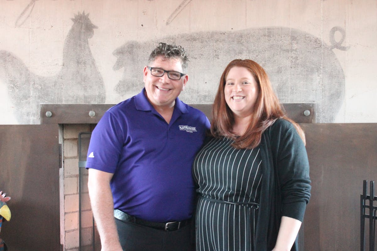 a man and a woman standing in front of a building