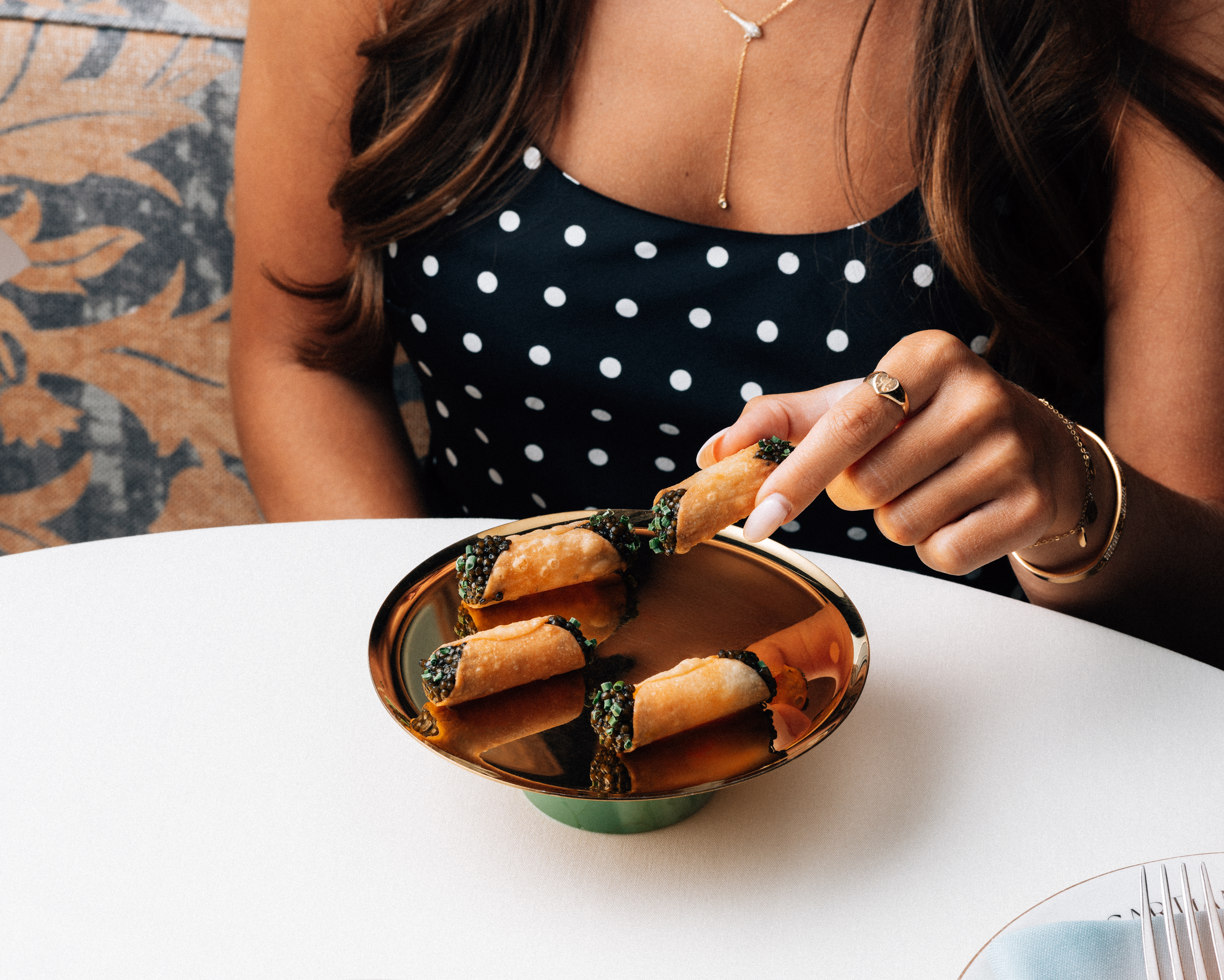 a woman sitting at a table with a plate of food