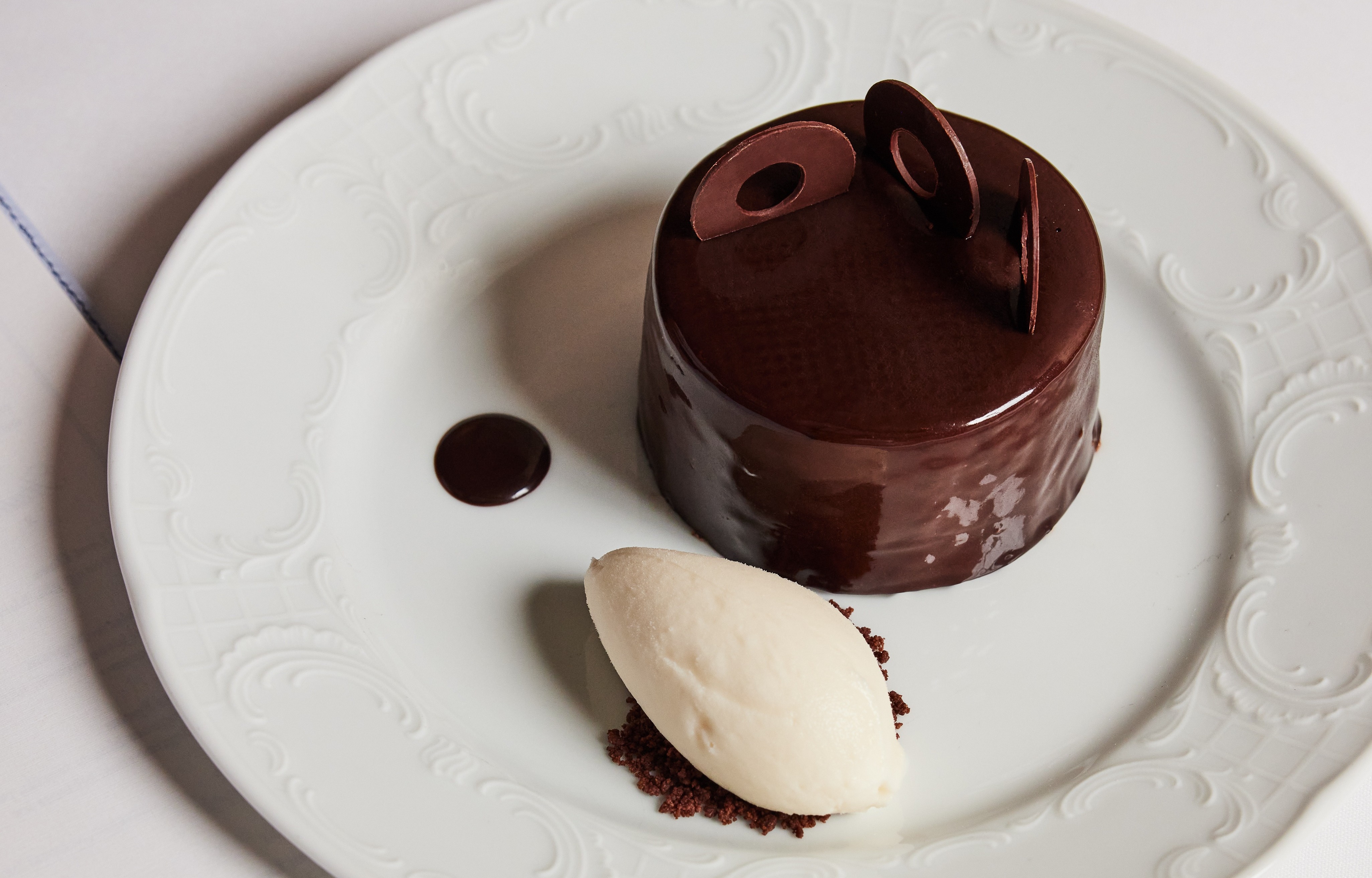 a close up of a chocolate cake with a dessert on a plate