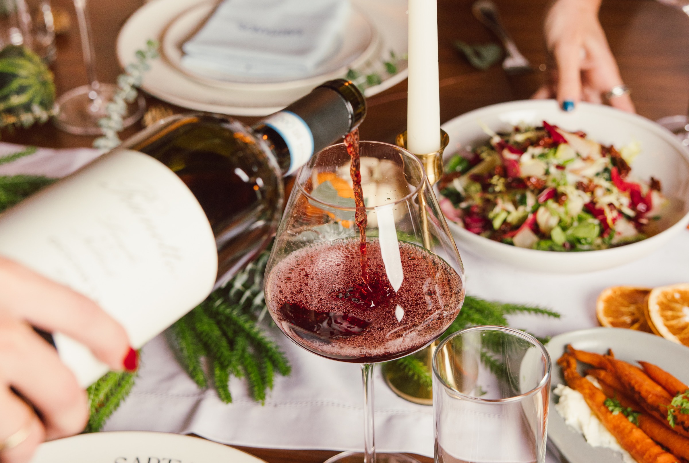a woman holding a plate of food on a table