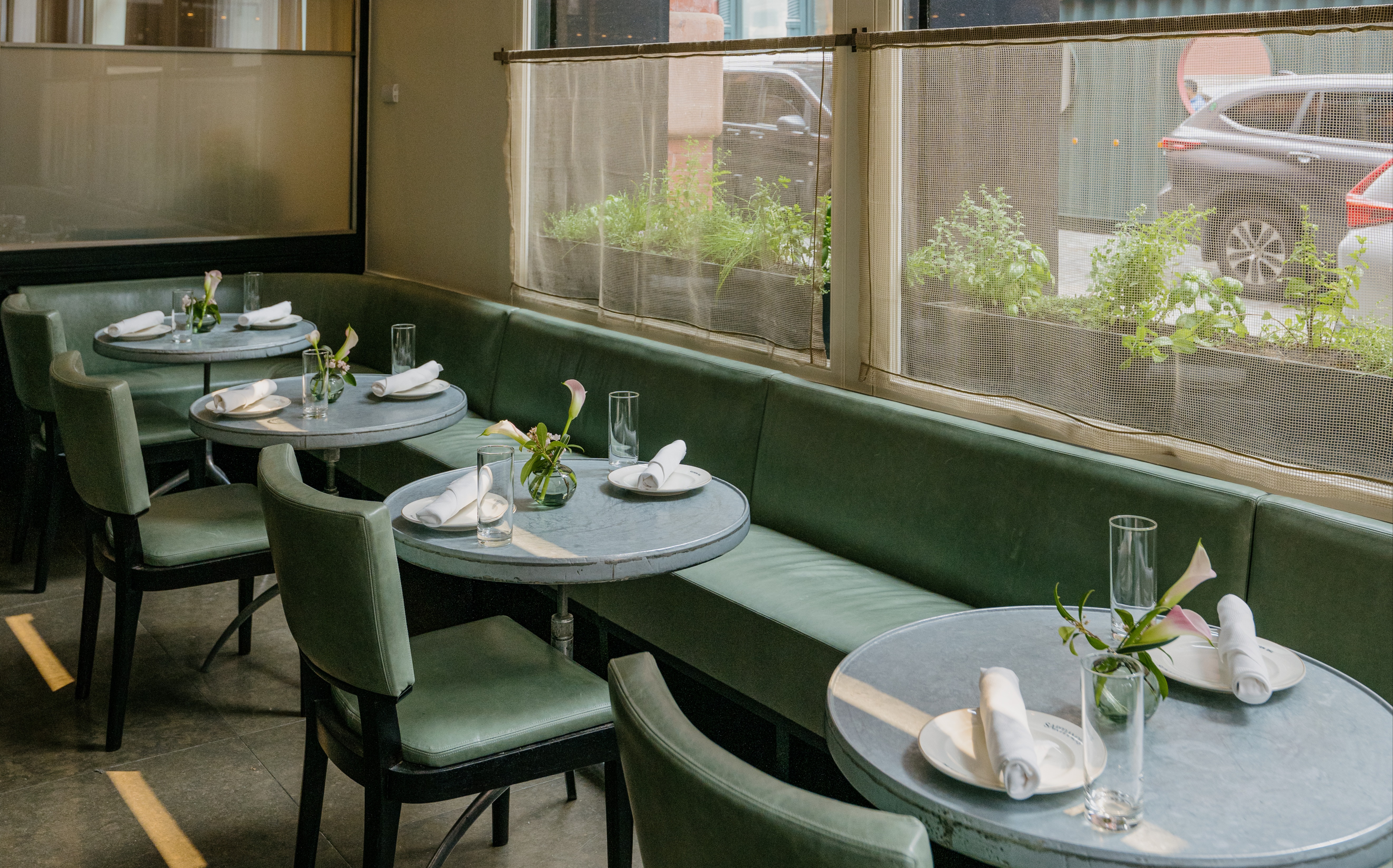 a person sitting at a table in front of a window