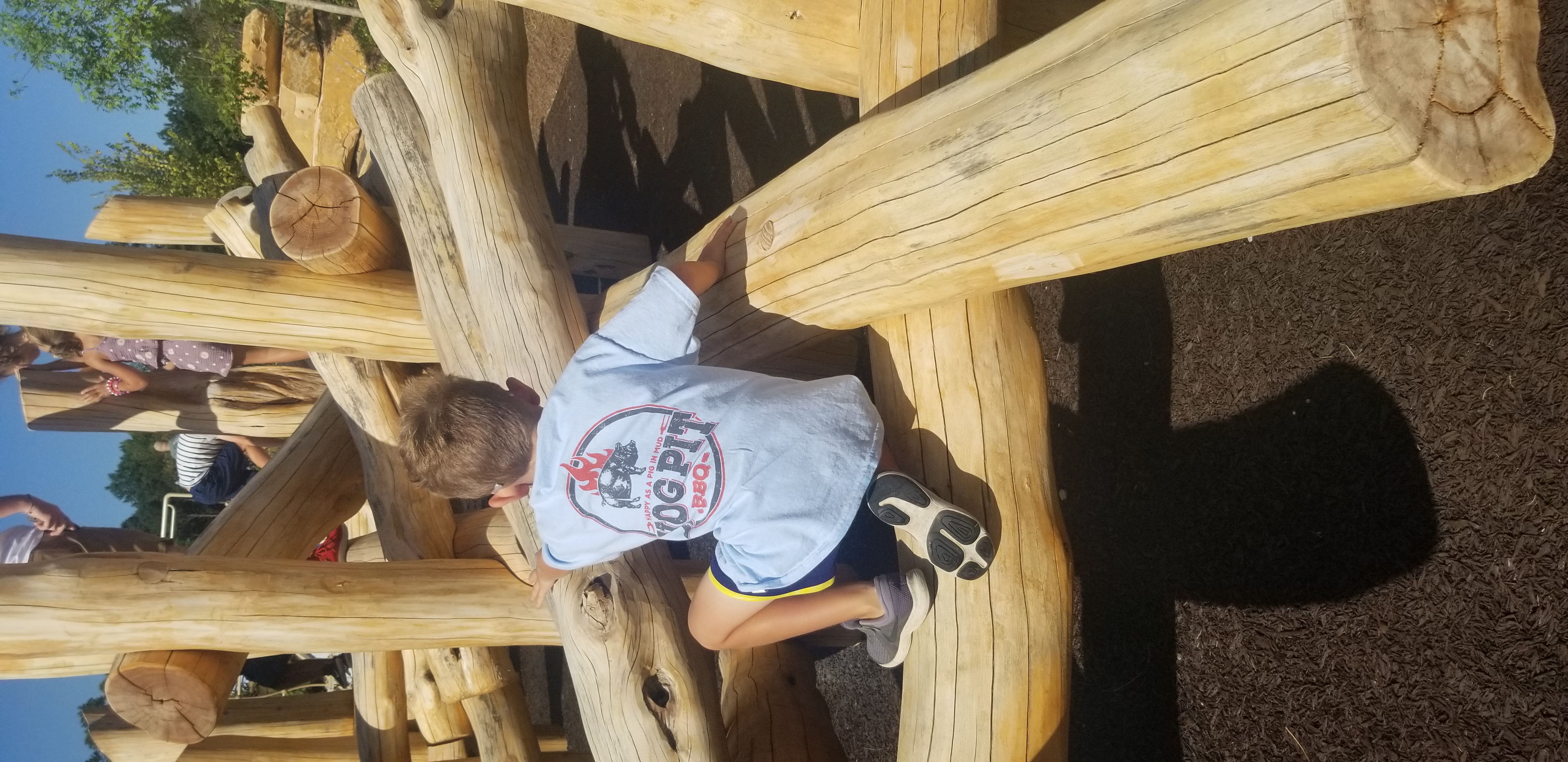 a person sitting on top of a wooden chair