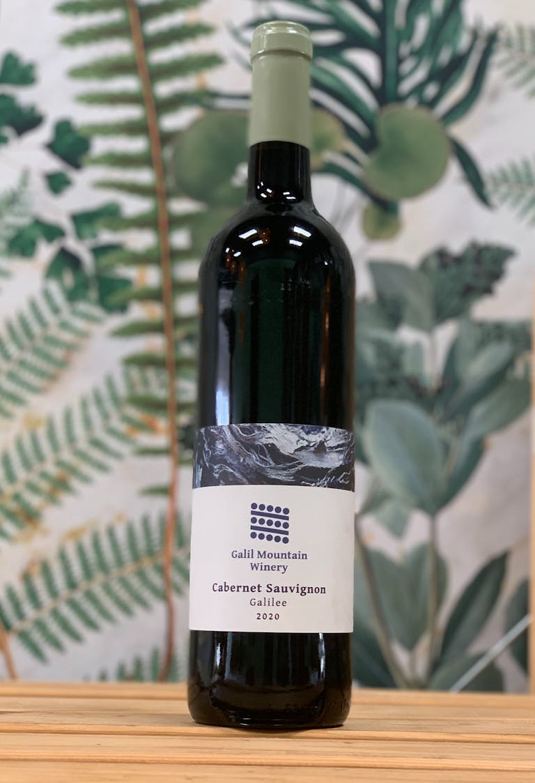 a close up of a bottle and a glass of wine