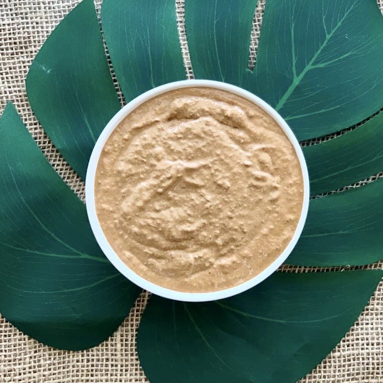 a cup of coffee sitting on top of a green plate