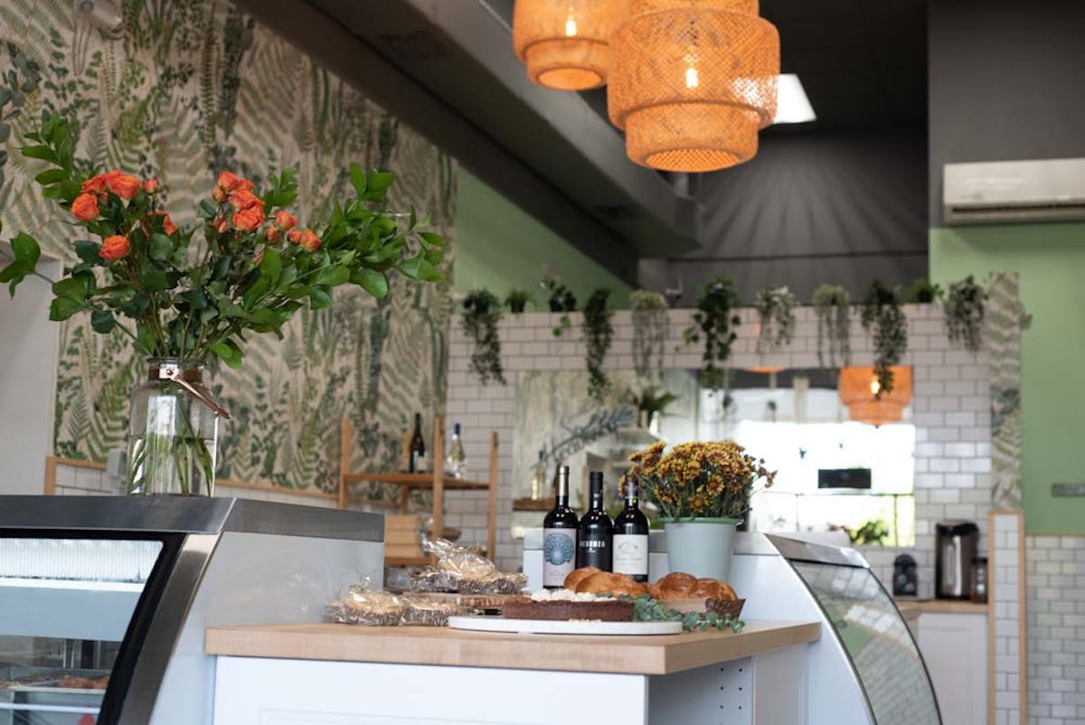 a vase of flowers on a kitchen counter