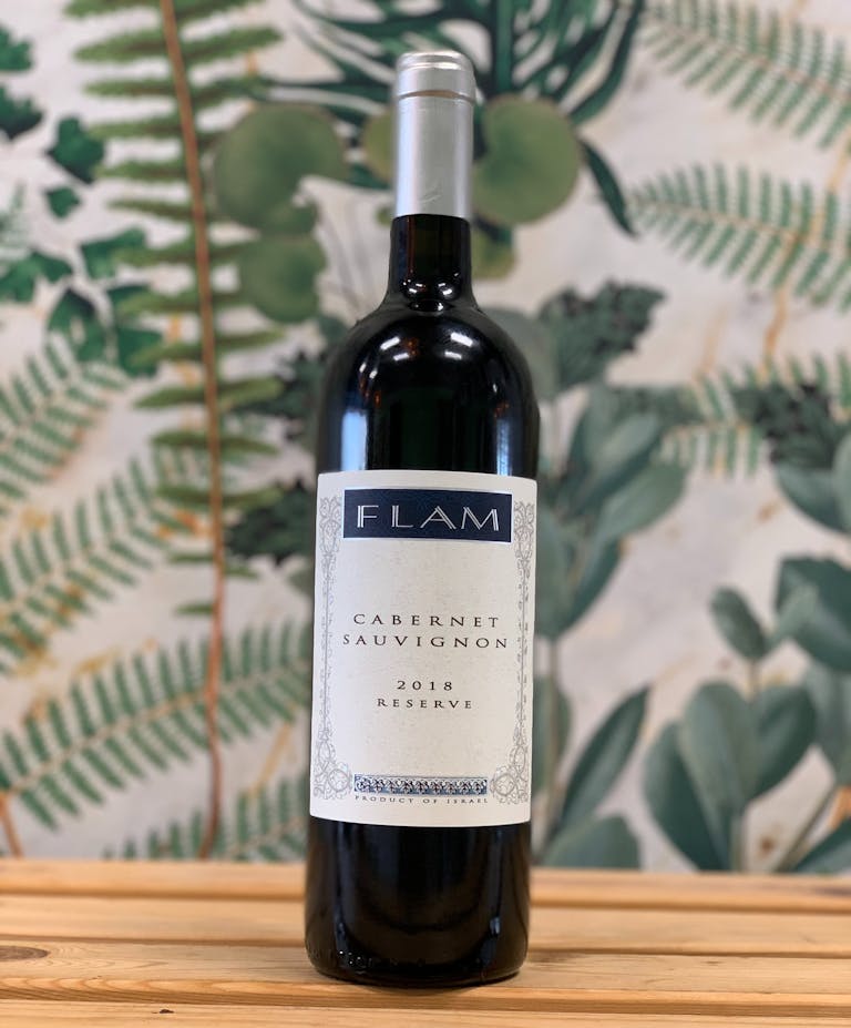 a close up of a bottle and a glass of wine