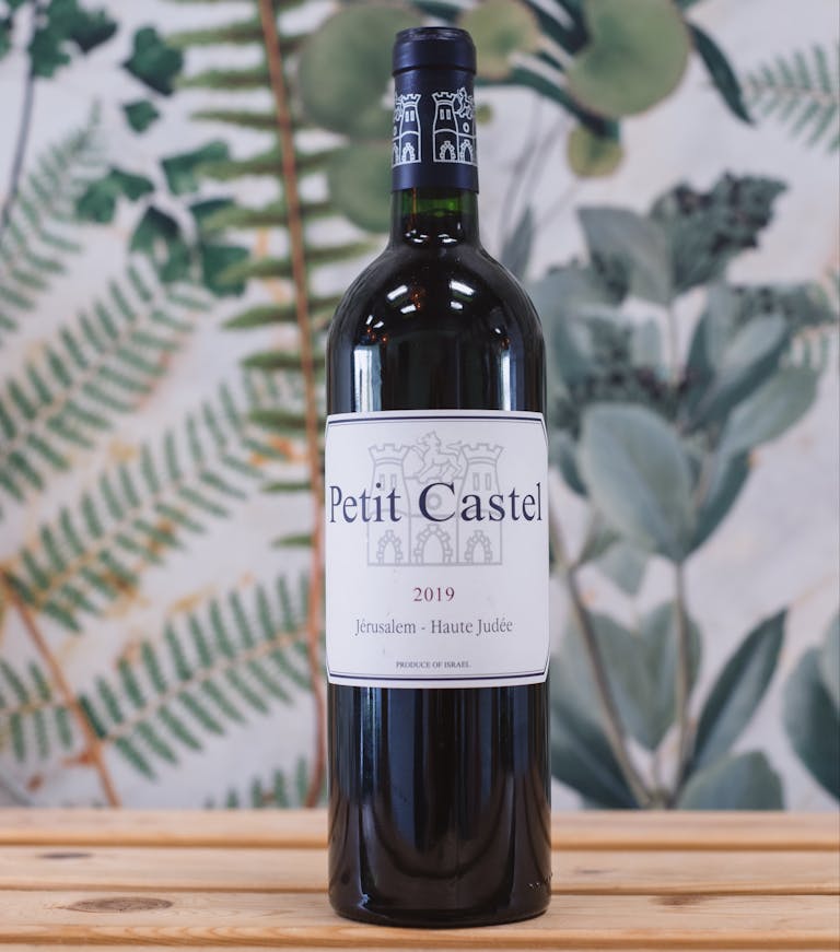 a close up of a bottle and a glass of wine