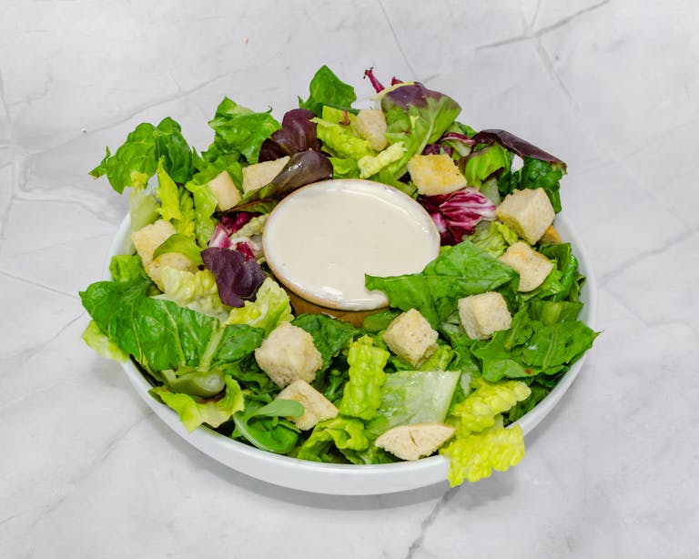 a plate of food with a green salad