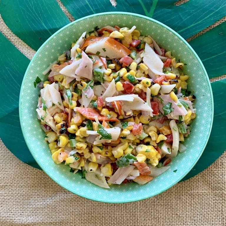 a bowl of salad on a blue plate