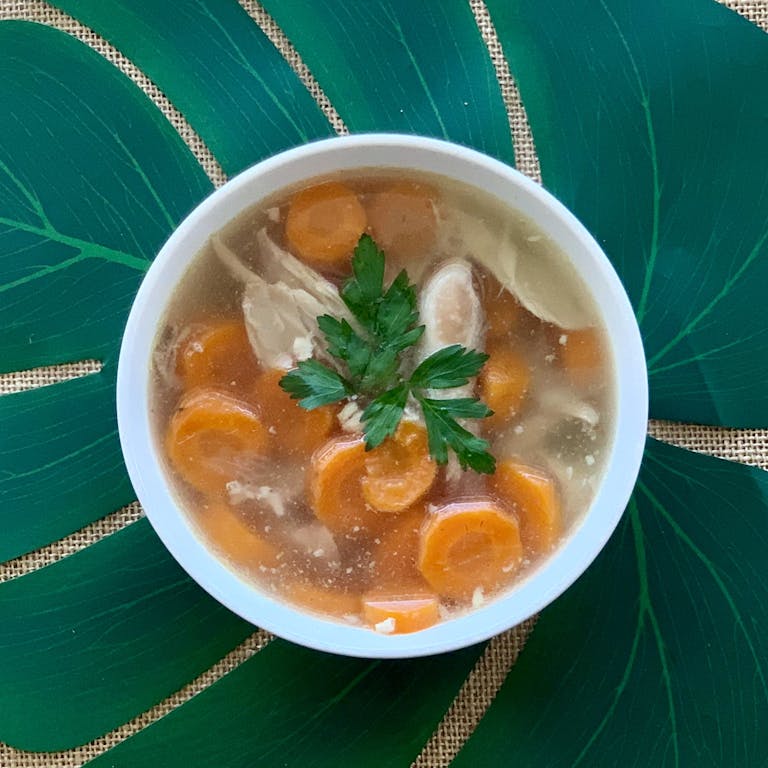 a bowl of soup sitting on a table
