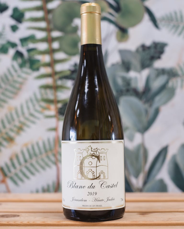 a close up of a bottle and a glass of wine