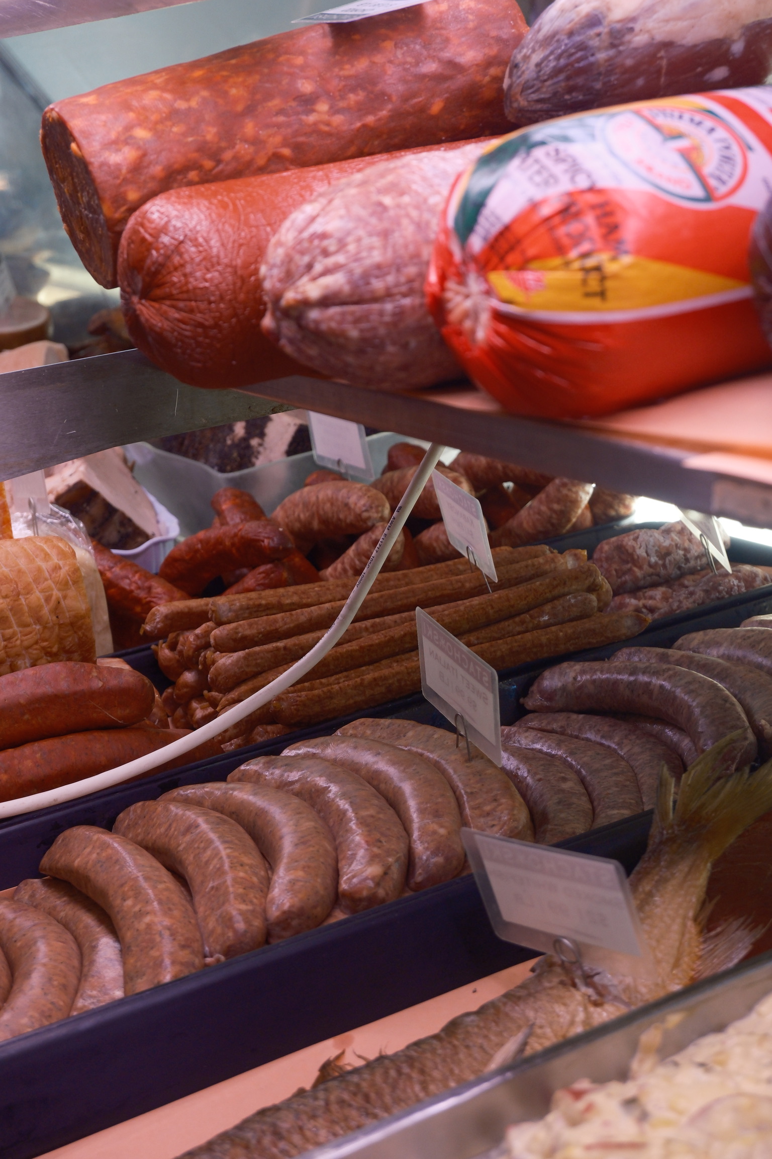 a shelf of meats and sausages
