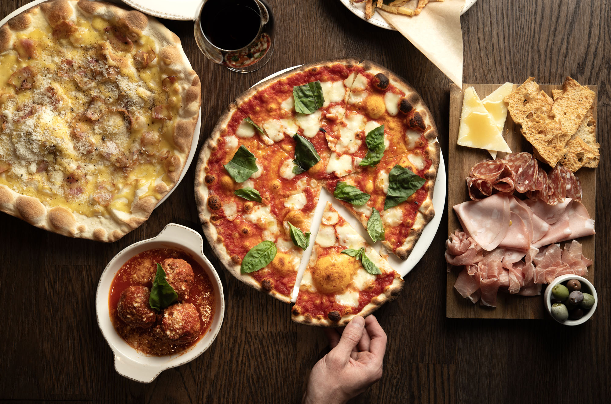 a pizza sitting on top of a wooden table